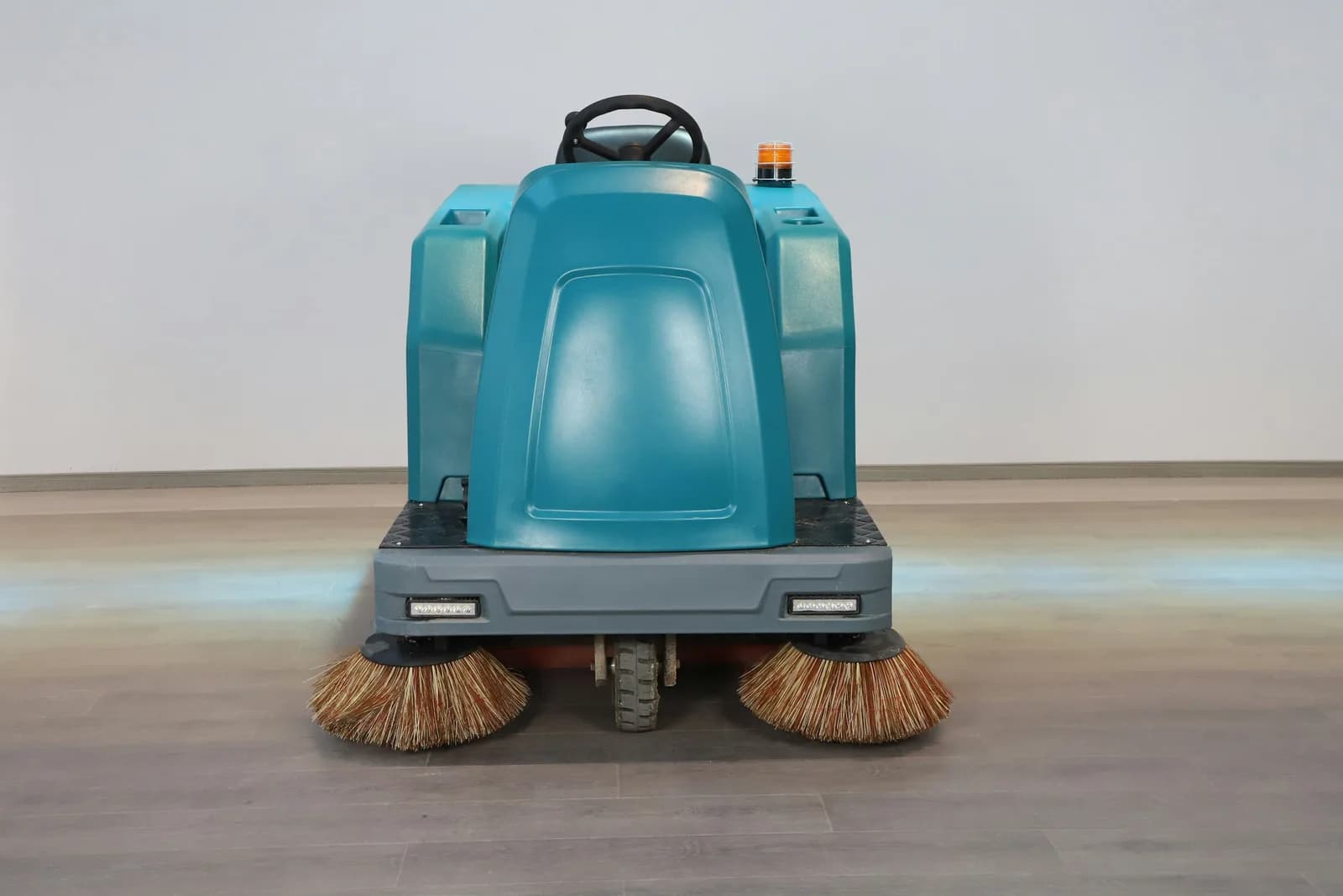 Ride-on floor sweeper with side brushes, available to rent by the day or month